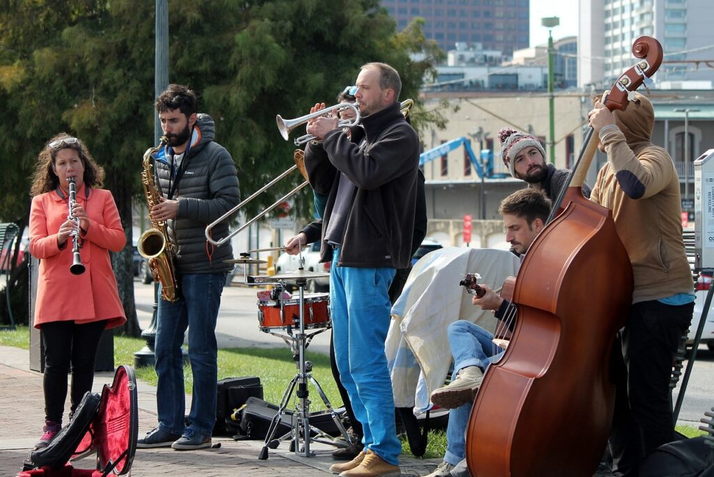 Cheap travel USA: A lively street in New Orleans with jazz musicians playing under colorful buildings