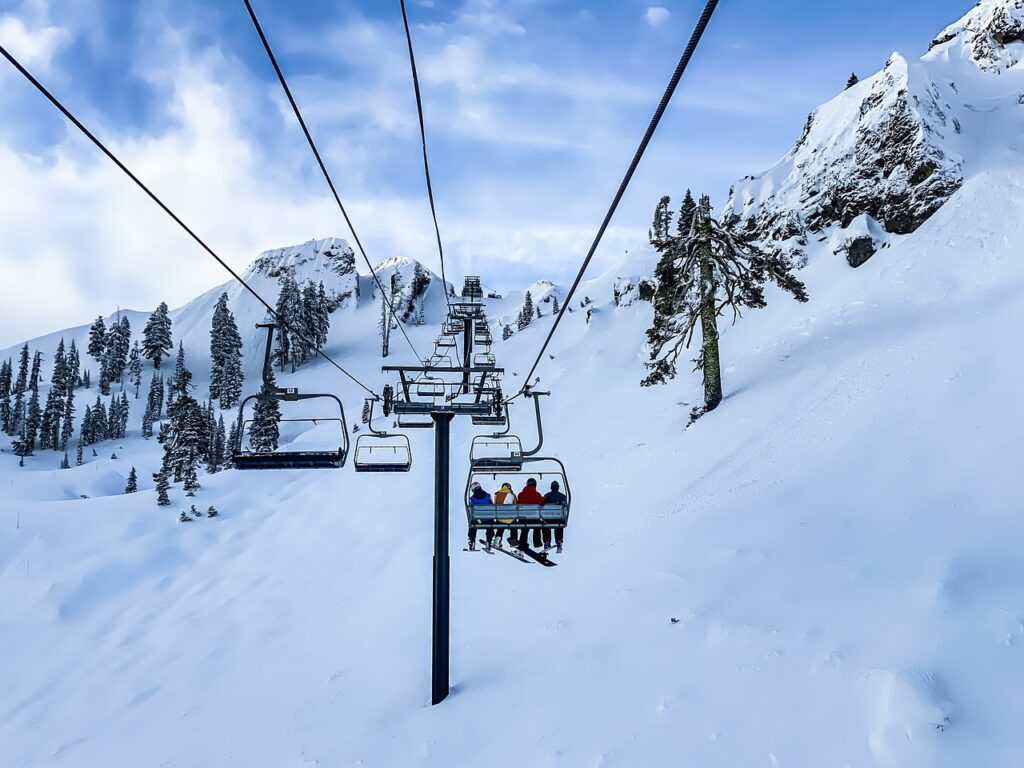 Cheap ski travel: Ski lift going up the snowy mountain in Jasná, Slovakia.