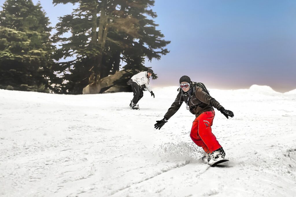 Cheap ski travel: Snowboarder on a sunny slope near Salt Lake City, Utah. Skiing outfits