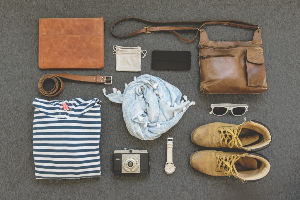 Essential day bag items for Barcelona in November including scarf, sunglasses, and reusable bottle